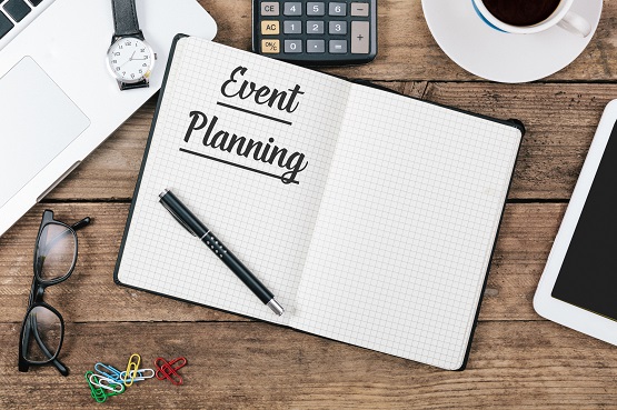 event planning notebook with a pen laying on top