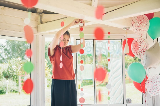 woman hanging party decorations